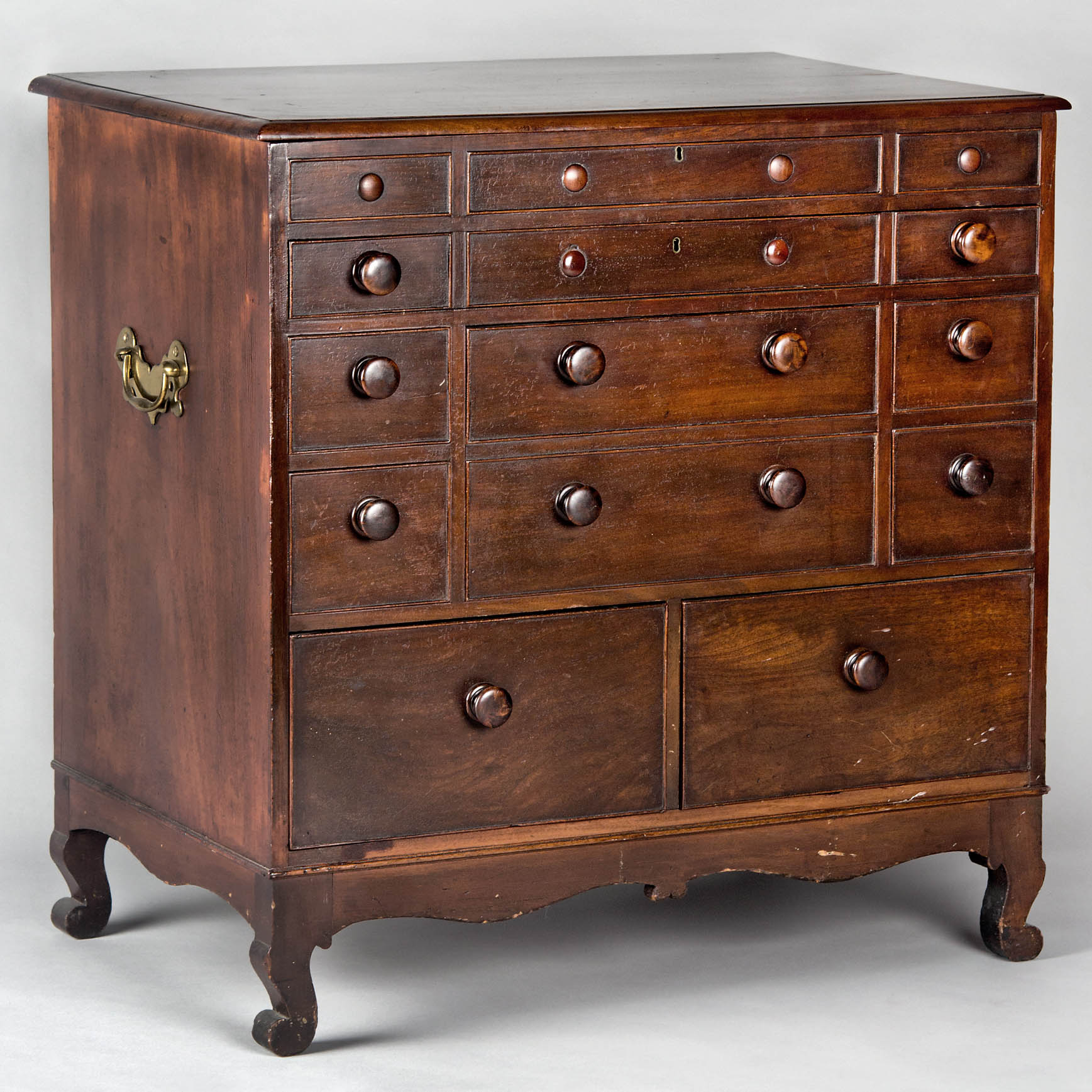 mahogany chest with several drawers and knobs