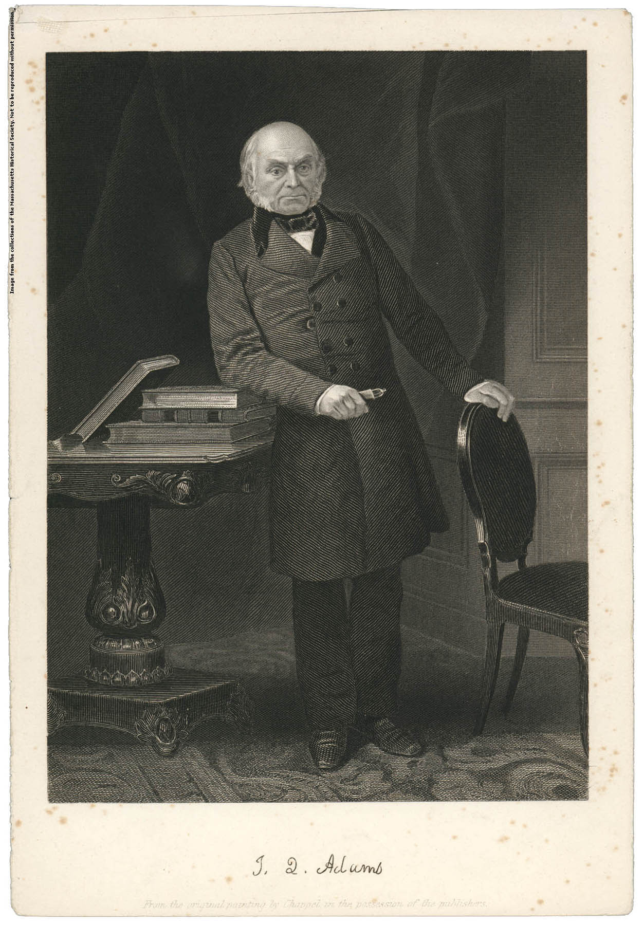 black-and-white photo of an elderly man in a long, buttoned coat and black pants standing with his left arm rested on the back of a chair and his left arm rested on a stack of books on top of an ornate side table. The image is labeled 