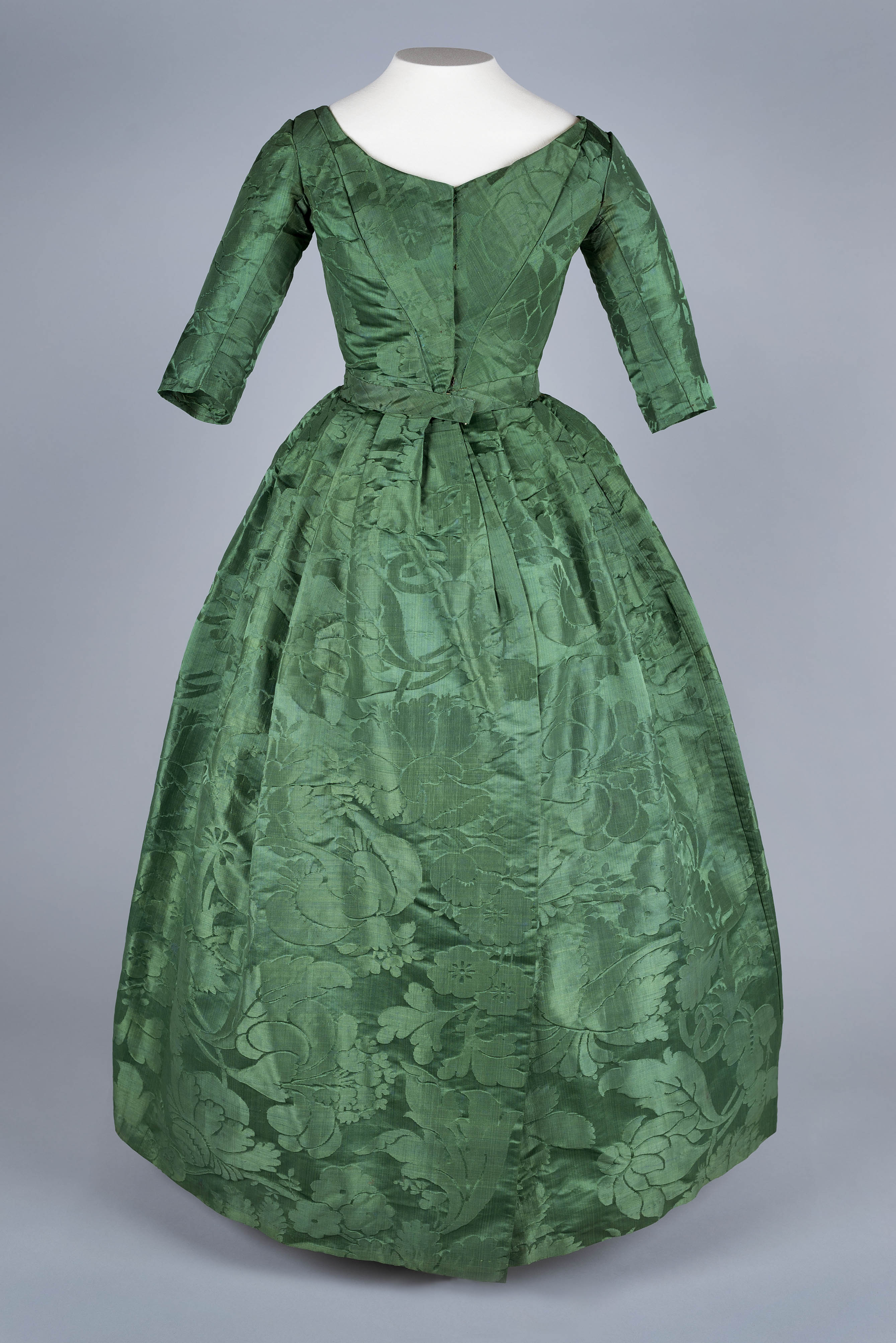 green silk dress with floral brocade pattern